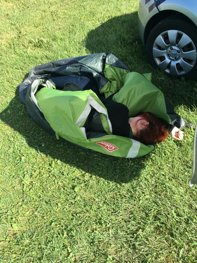 Pictured: E.A. Blackstock struggling singlehandedly with a tent because her friend showed up with a broken arm and could not help.